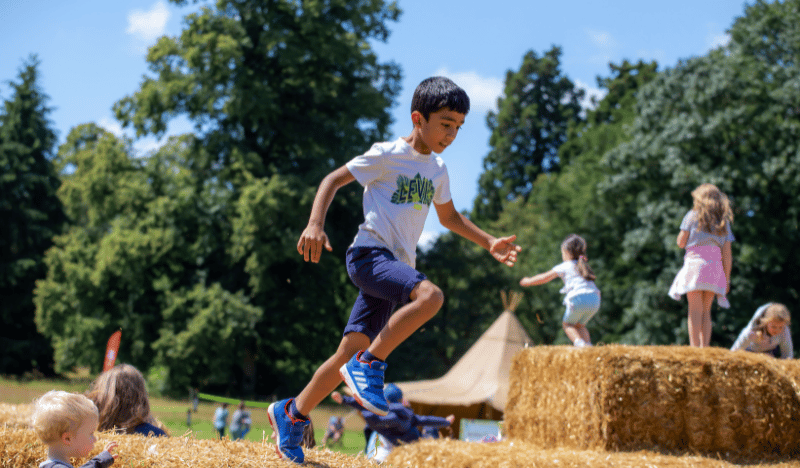 Photo of a young boy running in a field